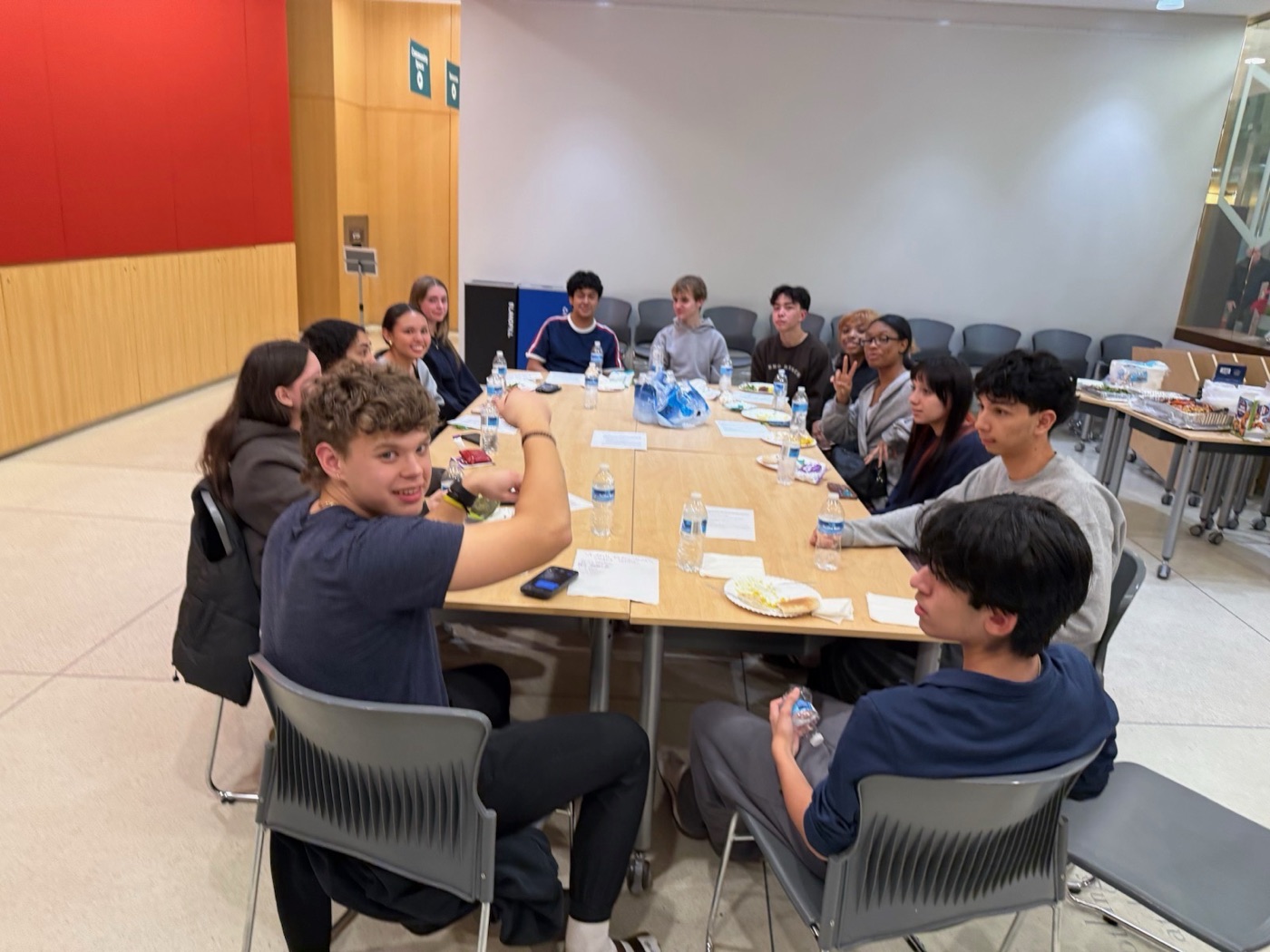 Students gathered around a table at an advisory council meeting
